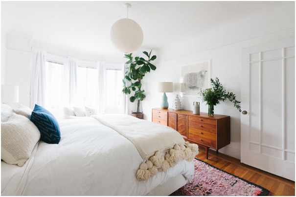 FabModula white themed master bedroom with indoor plants